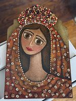 Front view of entire plaque showing painted portrait and bead embellishments