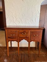 Front view of Ethan Allen pine huntboard sideboard showing drawers, hardware, apron and legs