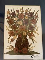 Full view of framed dried flower collage