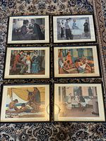 All six framed lithographs laid out on rug, front view