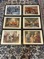 All six framed lithographs laid out on rug