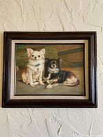 Front view of framed oil painting showing two chihuahuas
