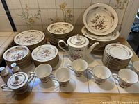 Full set showing stacked plates, cups, teapot, shakers
