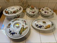 Five Royal Worcester Evesham lidded casserole dishes displayed together