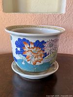 planter and saucer front view showing floral motif