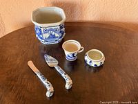 All five items: cachepot, cup, covered jar, two cheese utensils