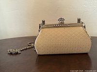 Front view showing body pattern, frame, clasp, chain