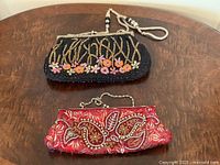 Both beaded coin purses on table