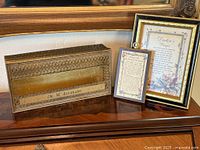 Overall lot showing tissue box and two framed prayers