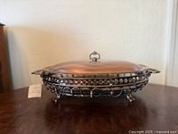 Full view of oval baker with lid on stand