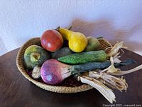 Wicker bowl with six faux vegetables, angled view