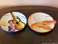 Both abstract ceramic plates side by side