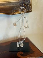 front view of clear lucite human figure on black base