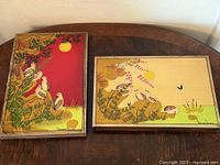 Both paintings side by side on table showing size and color contrast