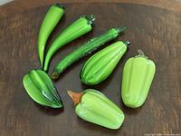 All six green Murano glass vegetable figurines on tabletop