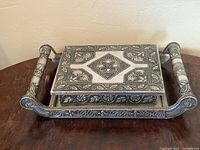 Three-quarter view showing full box, handles, and pattern