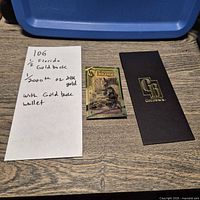 Front of Florida 1⁄2 Goldback note beside sleeve and handwritten lot note