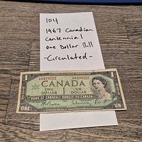 Obverse view of the 1967 Canadian $1 bill showing serial number and portrait
