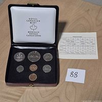 Open display case showing all seven coins