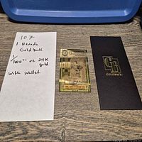 Goldback note with handwritten lot card and sleeve