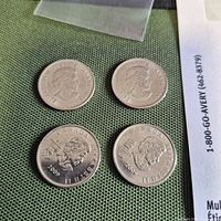 Four Canadian 2009 quarters showing obverse and one reverse design