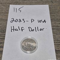 Front view showing coin on paper identifying year and mint