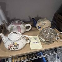 All four teapots on shelf