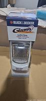 Front view of sealed Black & Decker Gizmo cordless grater box