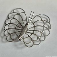 Front view of openwork sterling silver butterfly brooch
