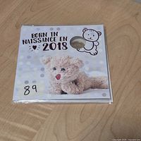 Front of sealed presentation card showing title and teddy bear artwork