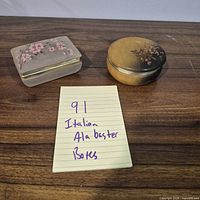 Both alabaster boxes side by side on table