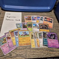 Group shot of all Japanese Pokémon cards fanned out on table