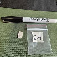 Silver bar beside Sharpie for scale and zip bag