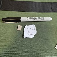 Silver bar beside marker and note for scale