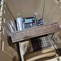 Overview of tote showing beige RDT corded phone, silver handset and other electronics