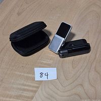 Samson Go Mic microphone open on its clip stand next to zippered case