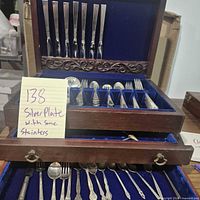Overall view showing flatware in wood chest and handwritten note