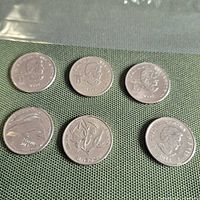 Obverse sides of six coins showing portrait of Queen Elizabeth II and dates 2017, 2012, 2008 etc.