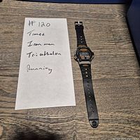 Full view of watch laid flat showing strap, case, overall condition