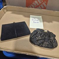 Overview of both vintage purses on tray