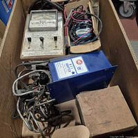 Box overview showing AC NEI Adapter, analog tester, wiring bundle