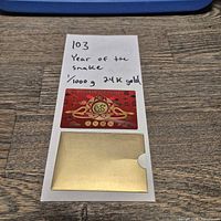Full view of Year of the Snake gold card and slip case on table