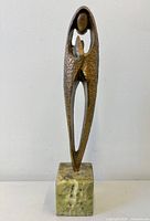 Front view of bronze Madonna sculpture on marble base