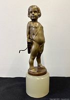 Full view of bronze Cupid sculpture on marble plinth