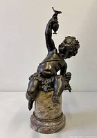 Full view of bronze putti sculpture front angle