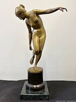 Full view of bronze nude dancer on marble base