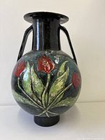 Front view of bulbous vase showing raised red tulip motif and handles
