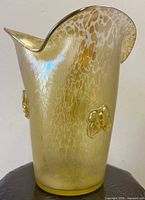 Side view showing iridescent mottled Papillon surface and wavy rim