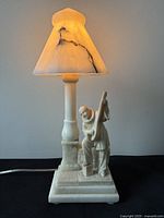Full view of carved alabaster Pierrot lamp illuminated