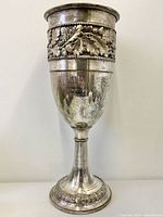 Full view of silver-plated cooler showing overall form and decorative band